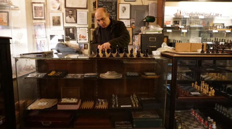 Imad Khachan behind the counter of his West Village chess shop. Khachan opened the Chess Forum in 1995 after a bitter feud with his business mentor. Photo credit: Neil Giardino